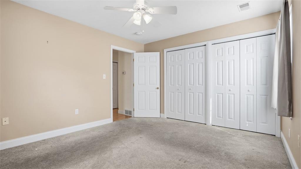 607 Locust Street Coraopolis, PA 15108 - Photo 11 of 18 an empty room with a ceiling fan and a window