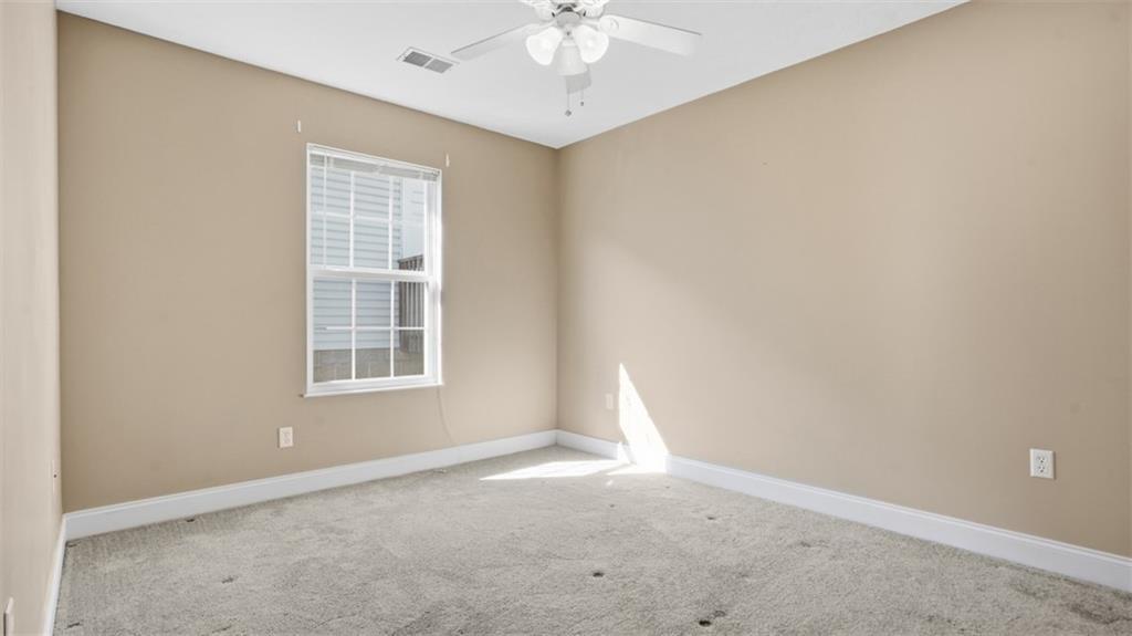 607 Locust Street Coraopolis, PA 15108 - Photo 13 of 18 an empty room with a chandelier fan and windows