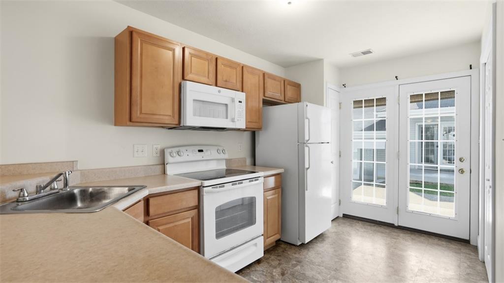 607 Locust Street Coraopolis, PA 15108 - Photo 7 of 18 a kitchen with stainless steel appliances granite countertop a refrigerator sink and stove