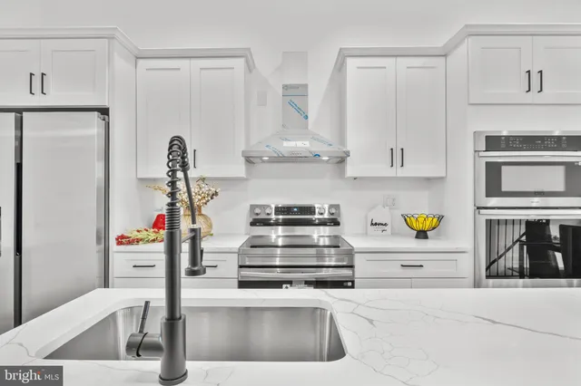 a kitchen with stainless steel appliances and a sink