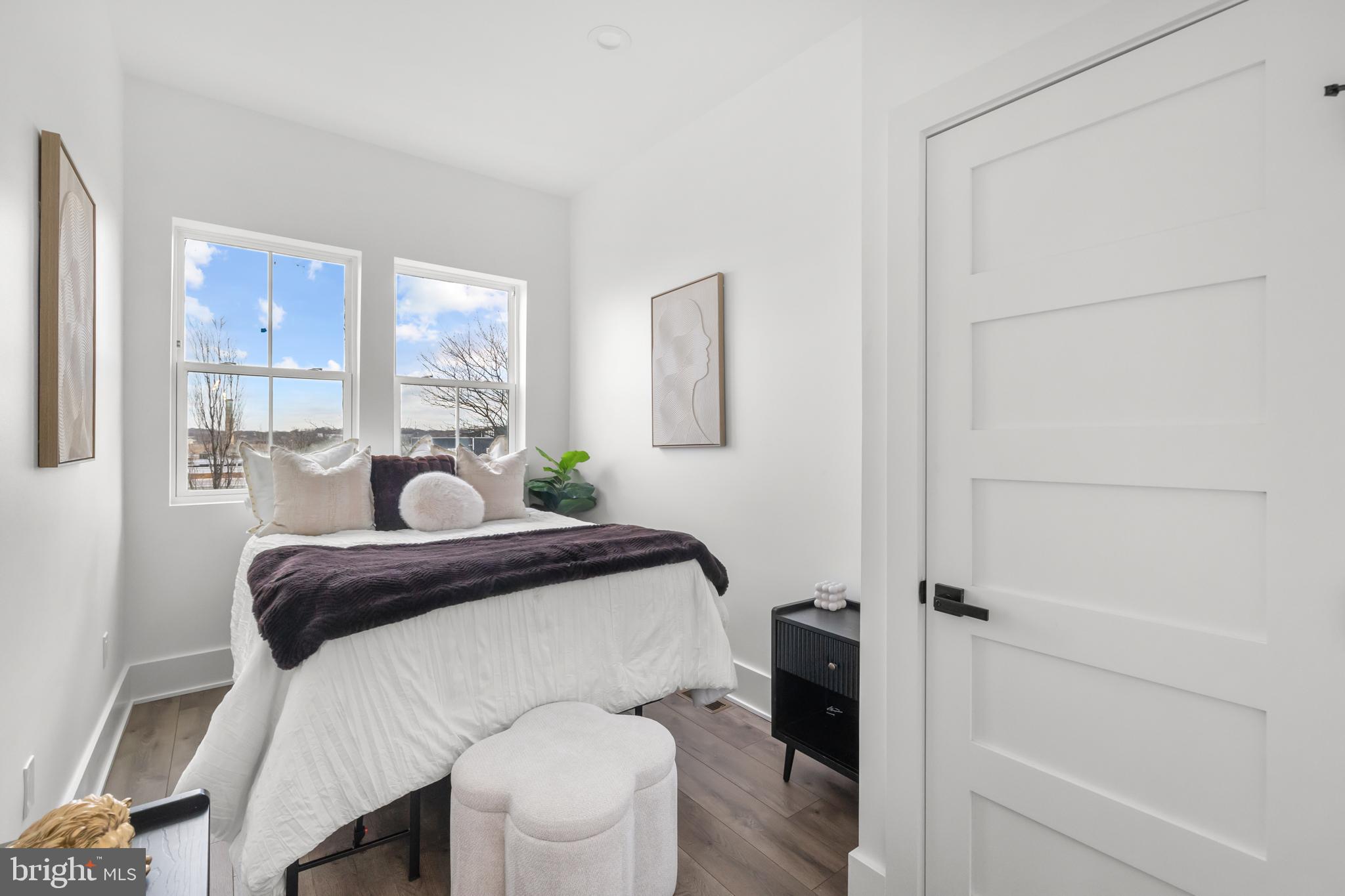 113 18th Street Southeast, Unit 2 Washington, DC 20003 - Photo 13 of 39 a bedroom with a bed and a table in it