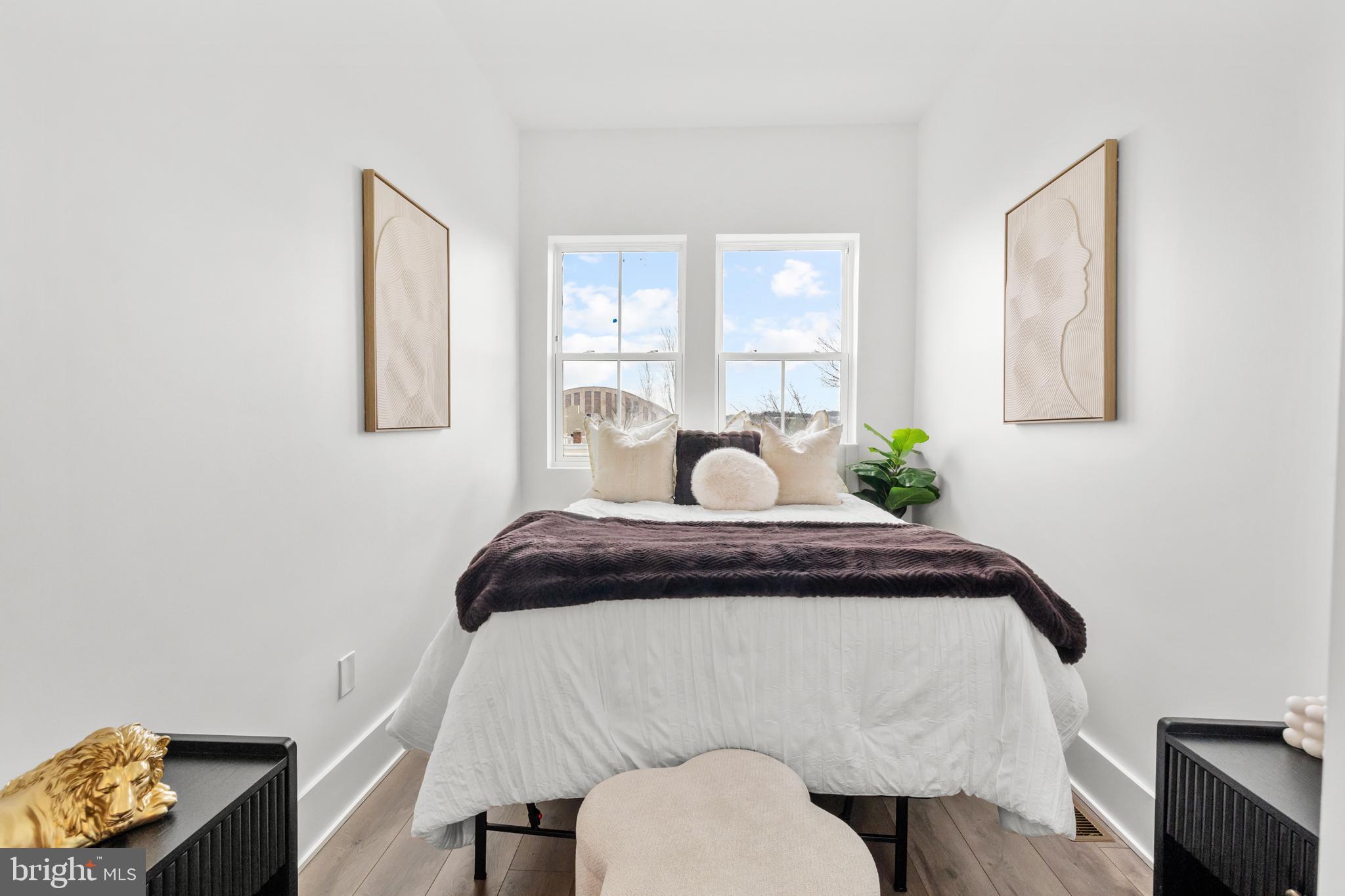 113 18th Street Southeast, Unit 2 Washington, DC 20003 - Photo 14 of 39 a bedroom with a bed and wooden floor
