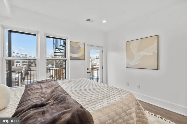 a bedroom with a large bed and a window