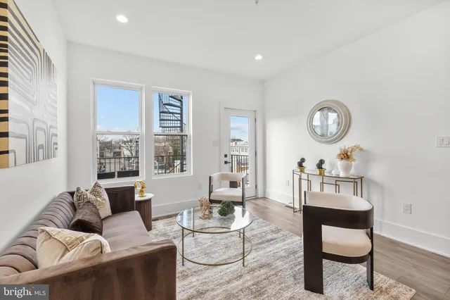 a living room with furniture a window and a table