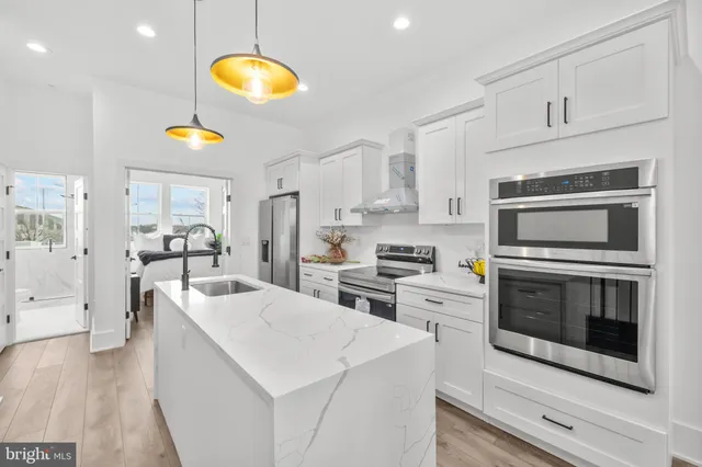 a kitchen with cabinets and steel stainless steel appliances