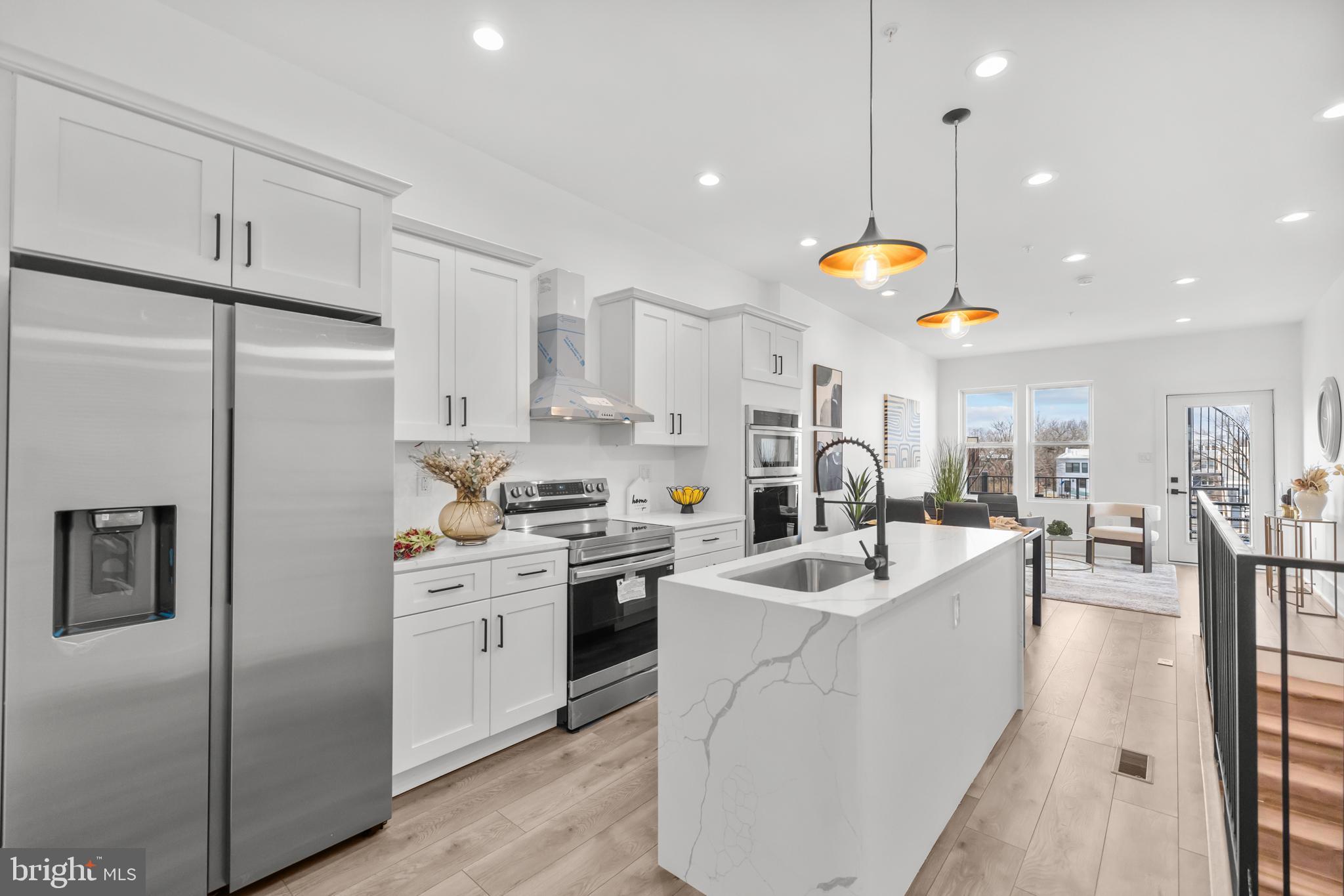 113 18th Street Southeast, Unit 2 Washington, DC 20003 - Photo 9 of 39 a kitchen with stainless steel appliances granite countertop a sink a stove and a refrigerator