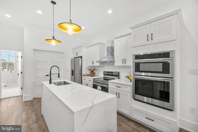 a kitchen with a sink a stove and cabinets