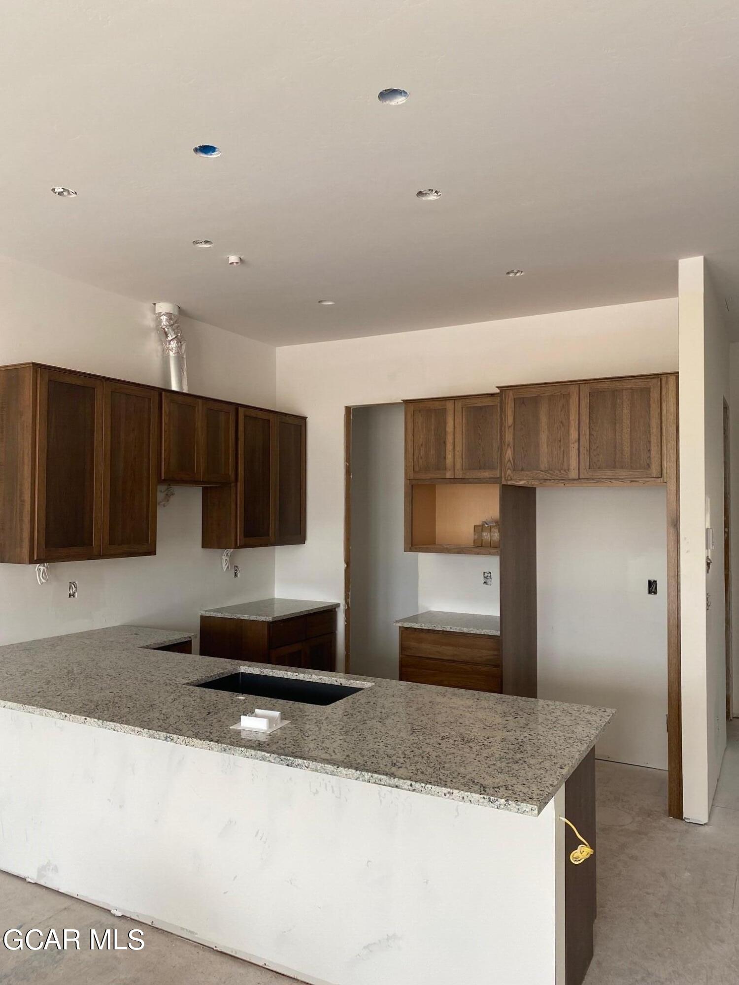 168 Hay Meadow Drive Fraser, CO 80442 - Photo 13 of 35 a kitchen with stainless steel appliances granite countertop a sink and a granite counter tops