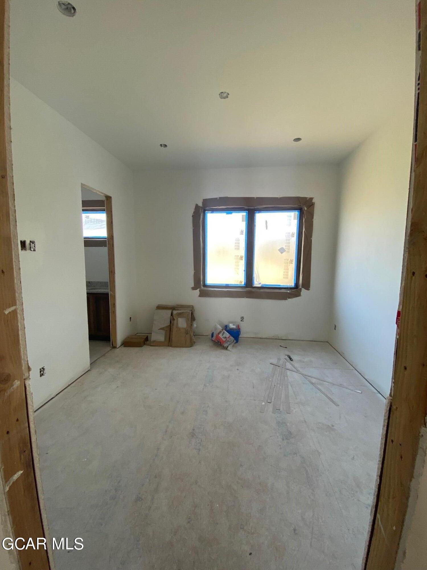 168 Hay Meadow Drive Fraser, CO 80442 - Photo 15 of 35 an empty room with a fireplace and windows