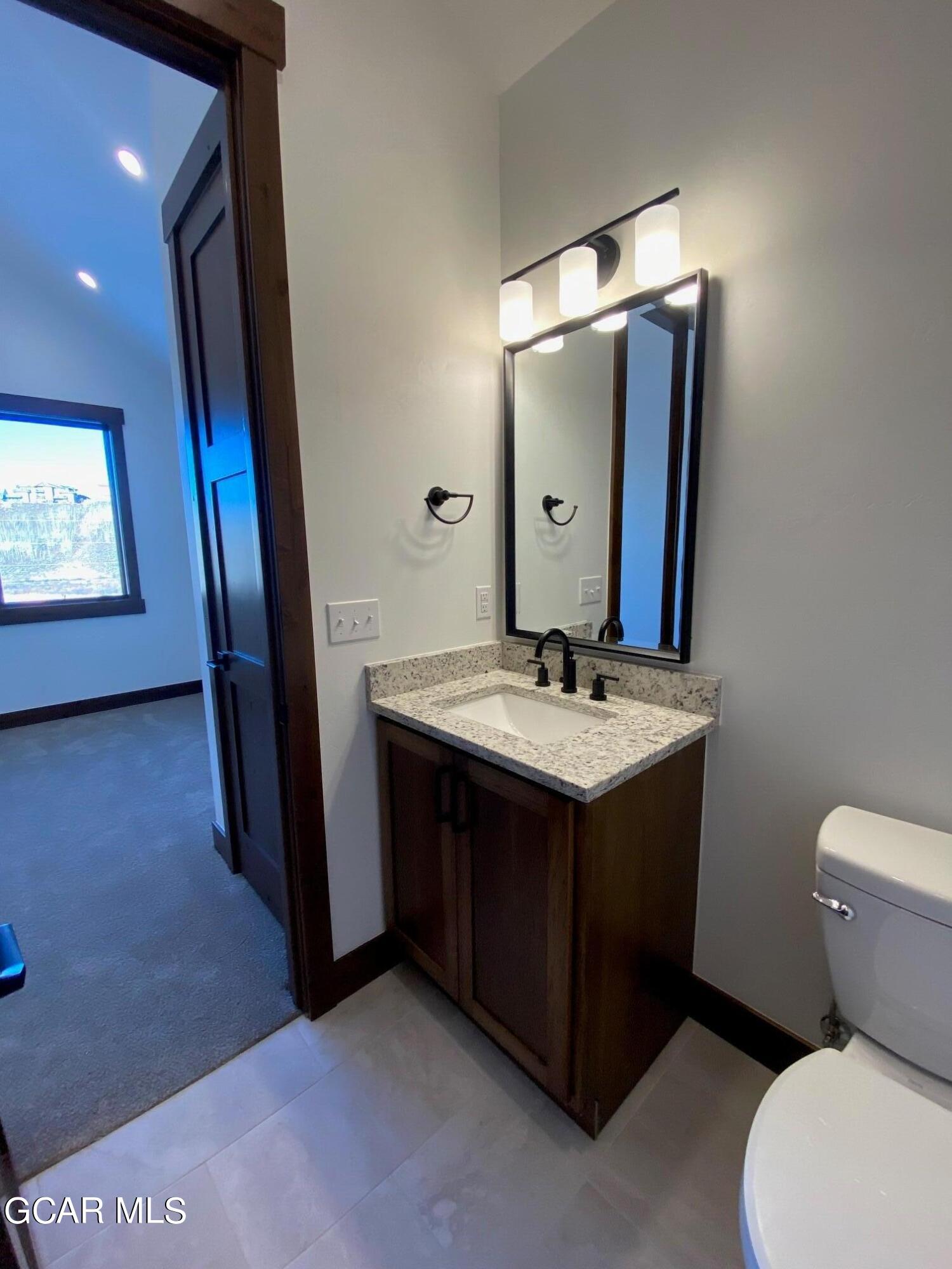 168 Hay Meadow Drive Fraser, CO 80442 - Photo 20 of 35 a bathroom with a sink vanity mirror and toilet