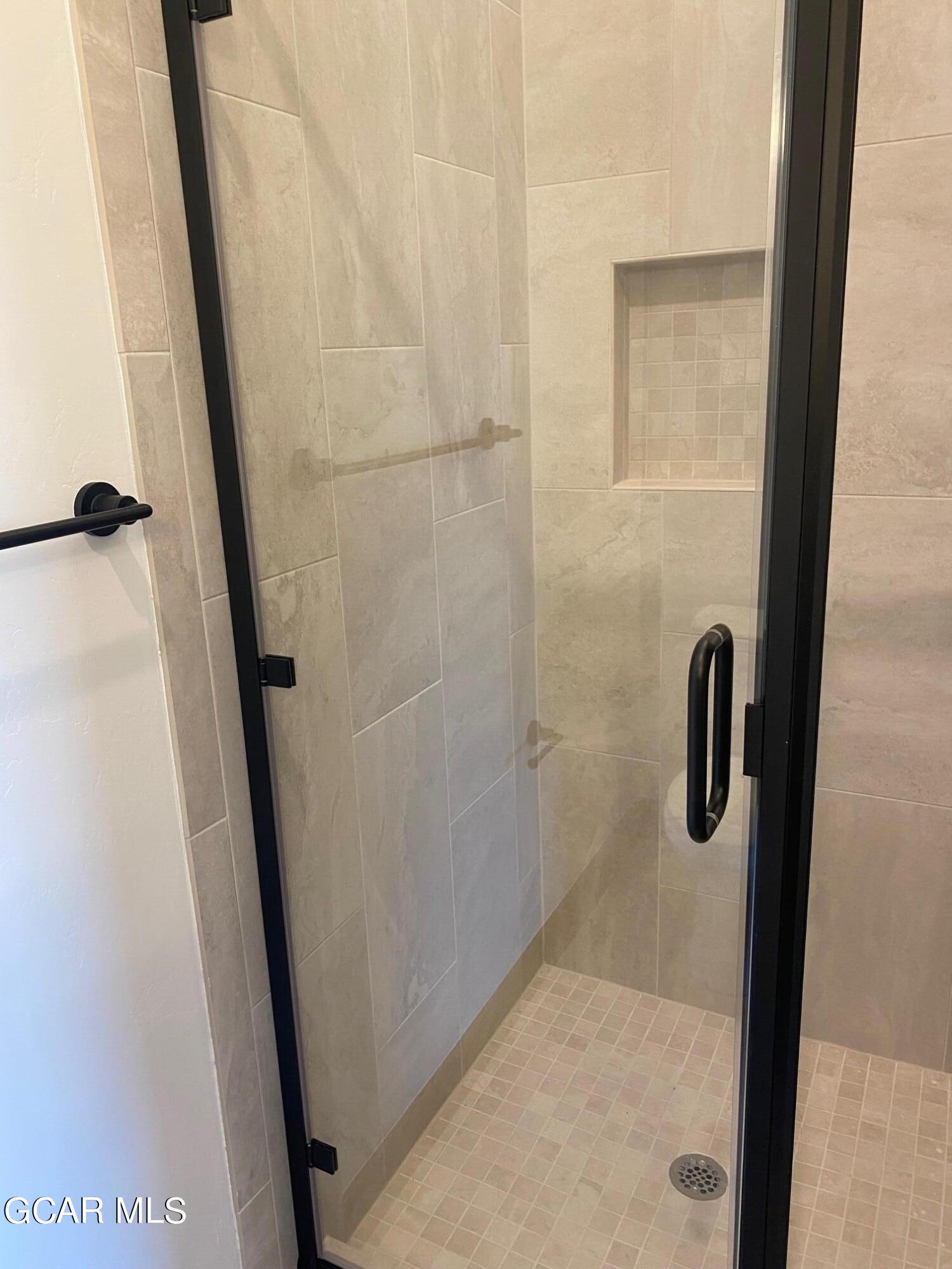 168 Hay Meadow Drive Fraser, CO 80442 - Photo 21 of 35 a bathroom with a glass shower door