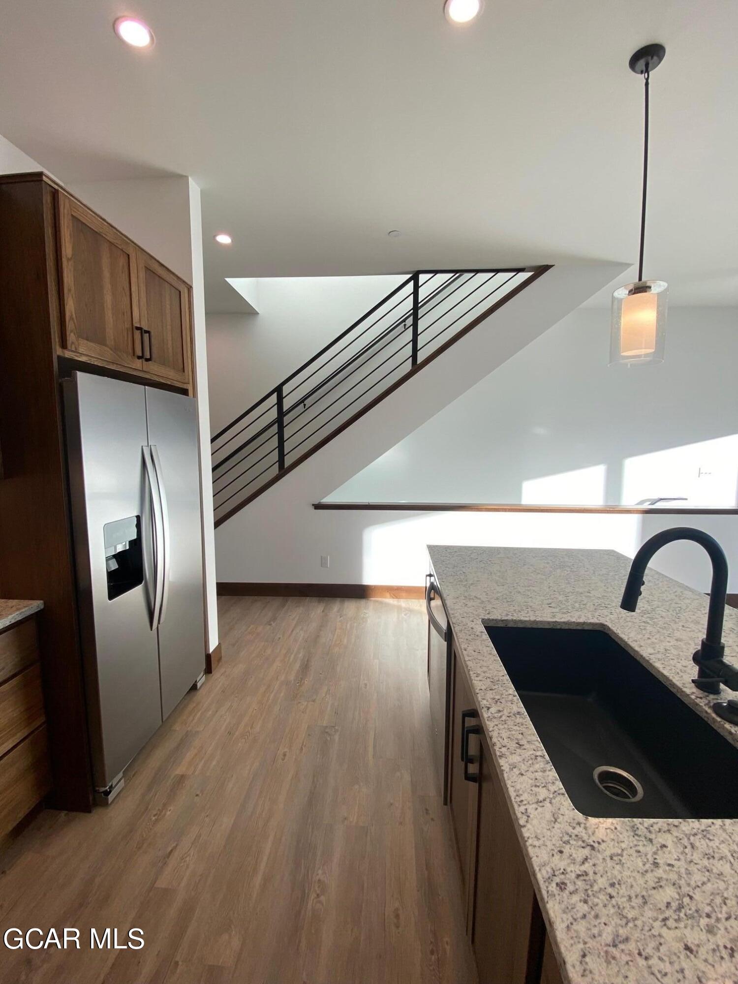 168 Hay Meadow Drive Fraser, CO 80442 - Photo 27 of 35 a kitchen with a sink a refrigerator and cabinets