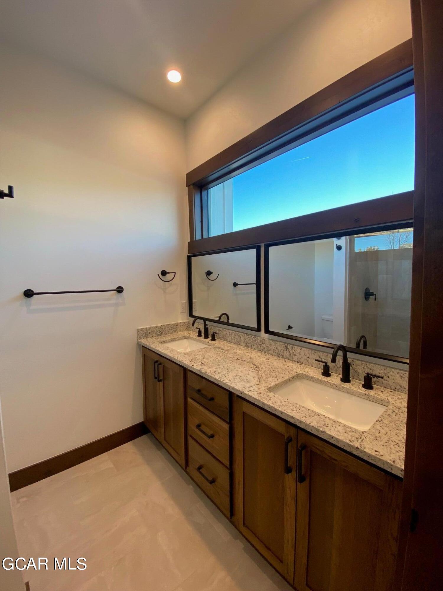 168 Hay Meadow Drive Fraser, CO 80442 - Photo 31 of 35 a bathroom with a granite countertop sink and a mirror