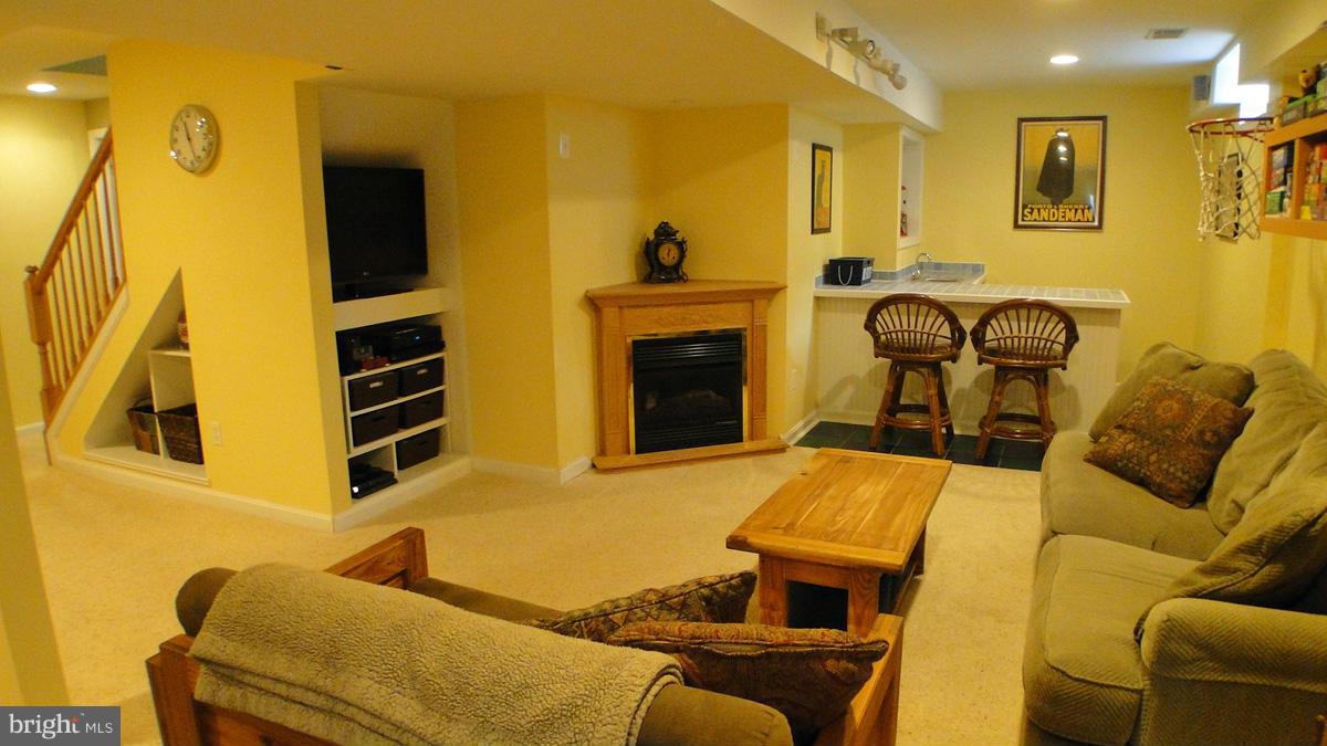 7671 Swallow Road Sykesville, MD 21784 - Photo 20 of 30 a living room with furniture and a fireplace