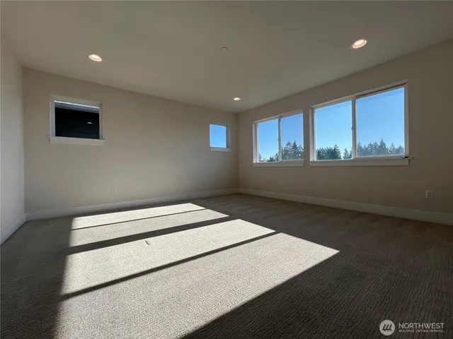 a view of wooden floor and windows in a room