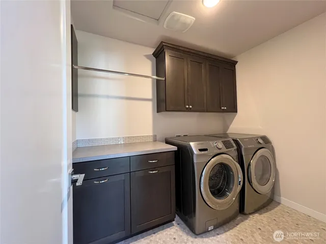 a utility room with sink dryer and washer