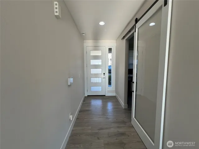 a view of hallway with wooden floor