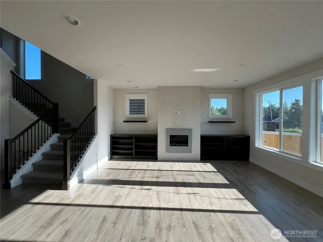 a view of an entryway with wooden floor and livingroom view