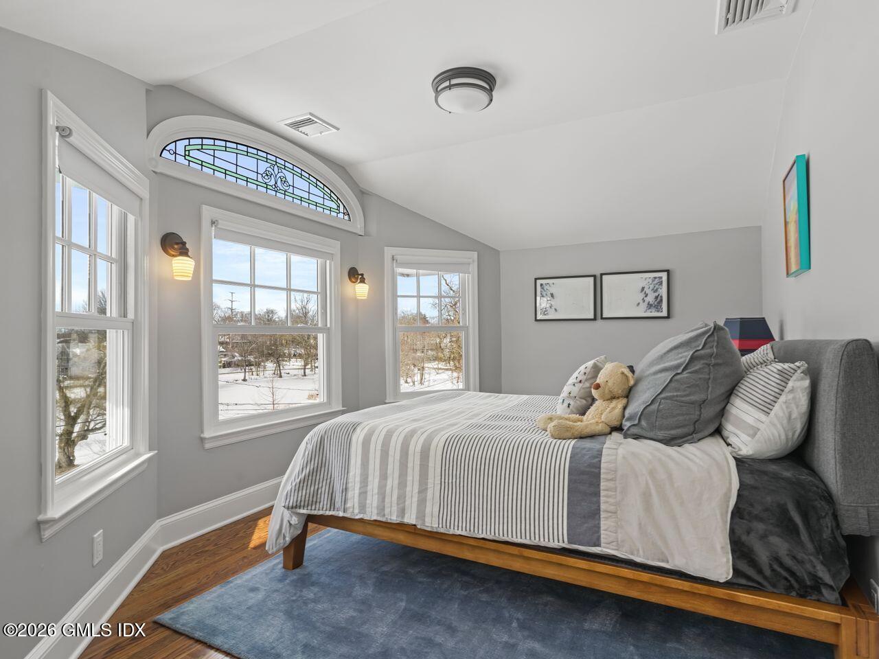 21 Lake Drive Riverside, CT 06878 - Photo 18 of 39 a bedroom with a bed and wooden floor