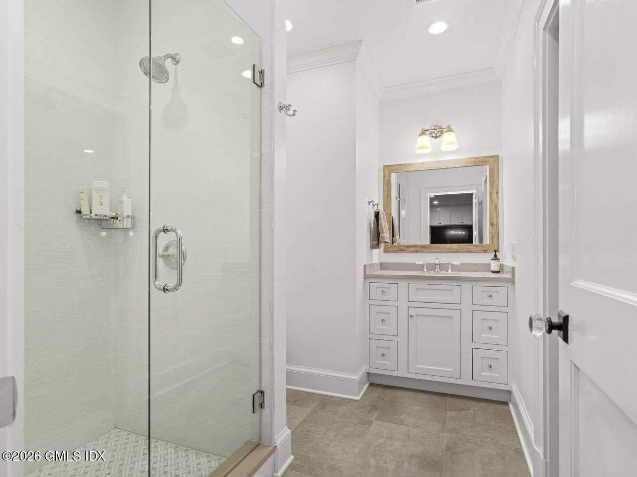 21 Lake Drive Riverside, CT 06878 - Photo 22 of 39 a bathroom with a shower sink and mirror