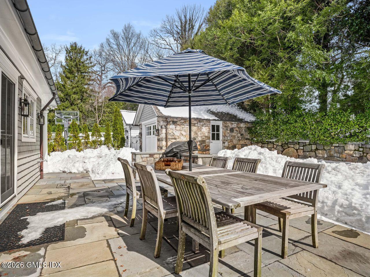 21 Lake Drive Riverside, CT 06878 - Photo 28 of 39 a view of a patio with a table and chairs under an umbrella