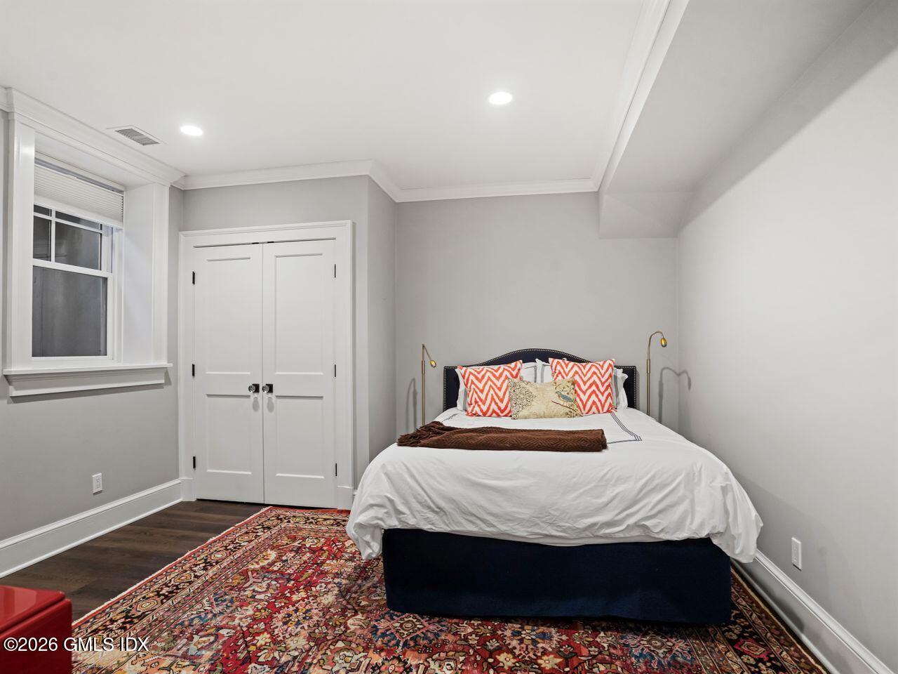 21 Lake Drive Riverside, CT 06878 - Photo 32 of 39 a bedroom with a bed and wooden floor