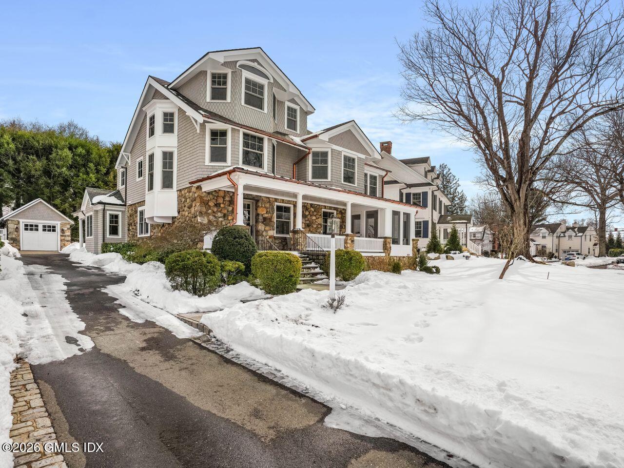 21 Lake Drive Riverside, CT 06878 - Photo 35 of 39 a front view of a building with snow on the road