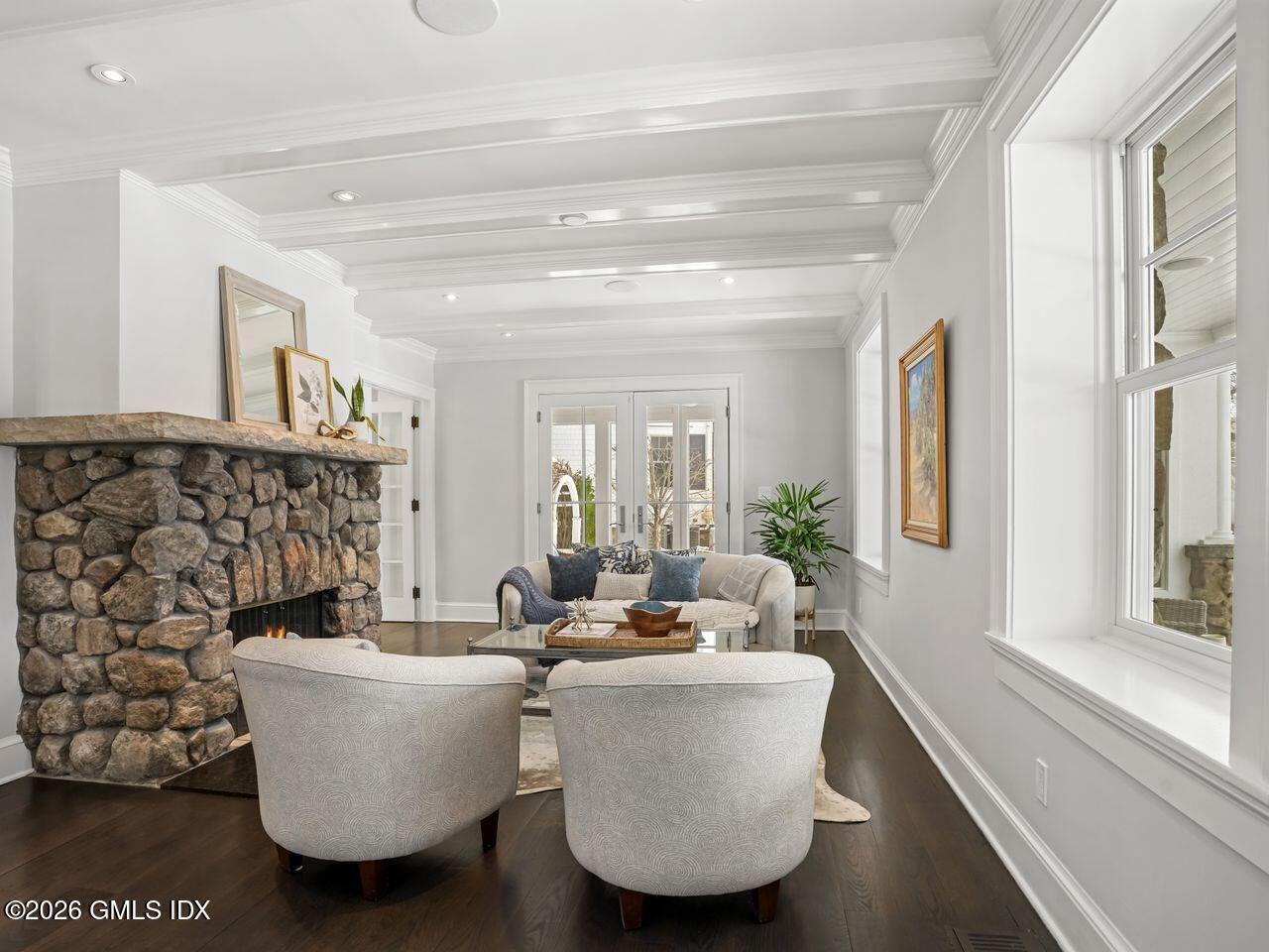 21 Lake Drive Riverside, CT 06878 - Photo 4 of 39 a living room with couches and a potted plant on a coffee table