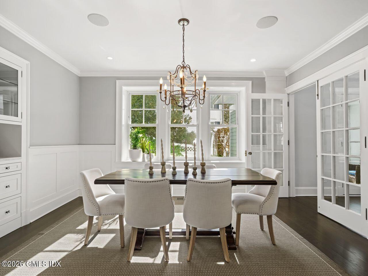 21 Lake Drive Riverside, CT 06878 - Photo 6 of 39 a dining room with furniture a chandelier and wooden floor