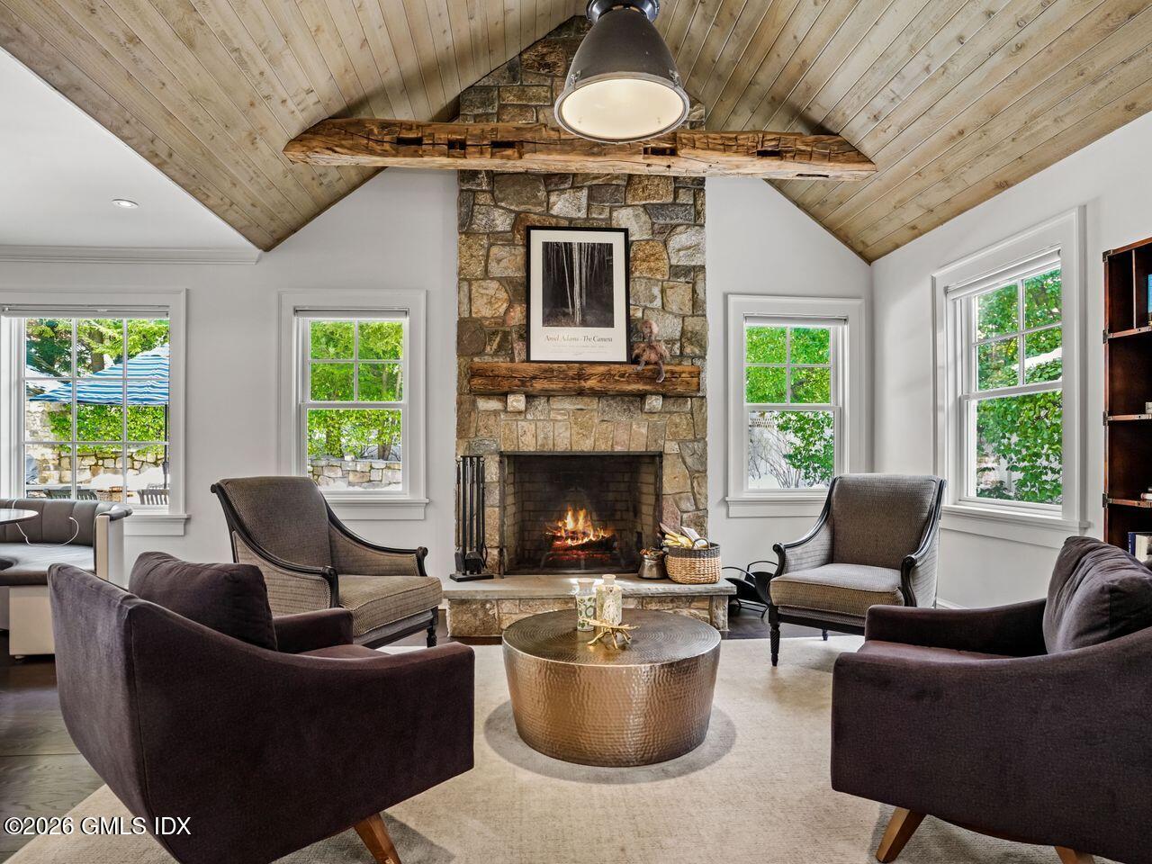 21 Lake Drive Riverside, CT 06878 - Photo 7 of 39 a living room with furniture a fireplace and a large window