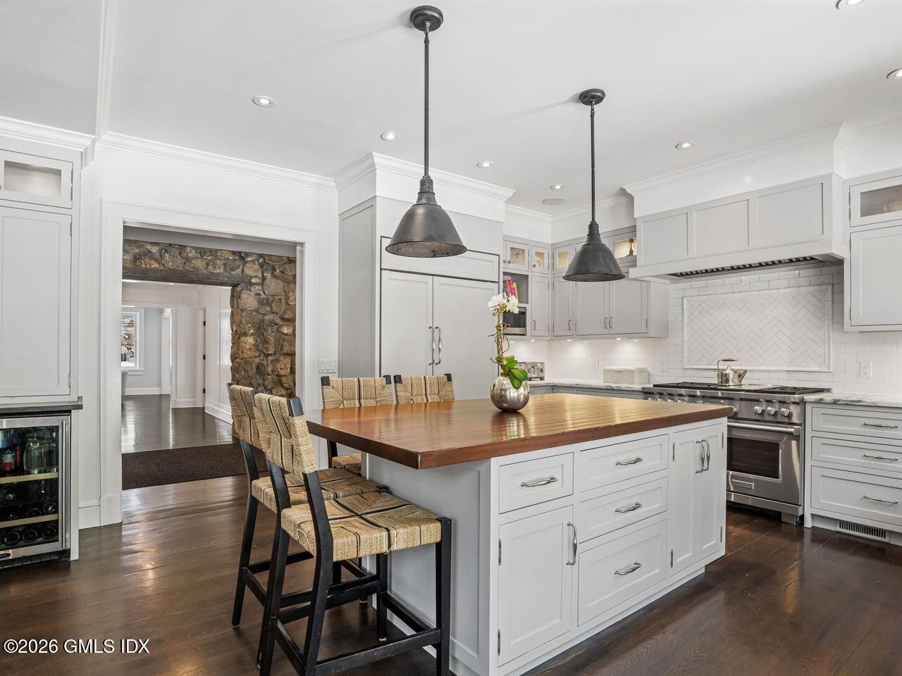 21 Lake Drive Riverside, CT 06878 - Photo 9 of 39 a kitchen with stainless steel appliances kitchen island granite countertop a stove a sink and a wooden floors