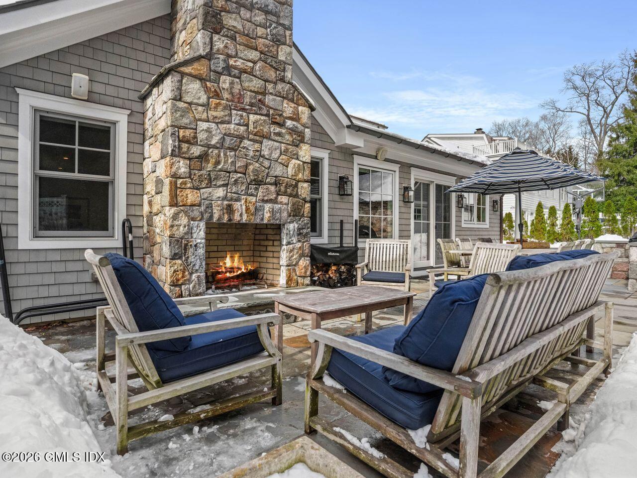 21 Lake Drive Riverside, CT 06878 - Photo 10 of 39 a outdoor space with a couch and a fireplace