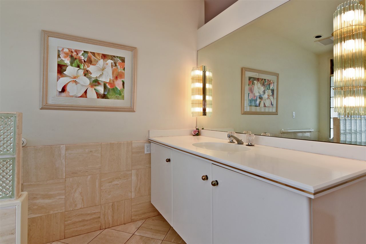 166 Halelo Street Lahaina, HI 96761 - Photo 16 of 27 a bathroom with a sink a large mirror and a window