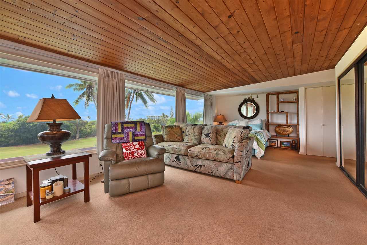 166 Halelo Street Lahaina, HI 96761 - Photo 19 of 27 a living room with furniture a fireplace and a large window
