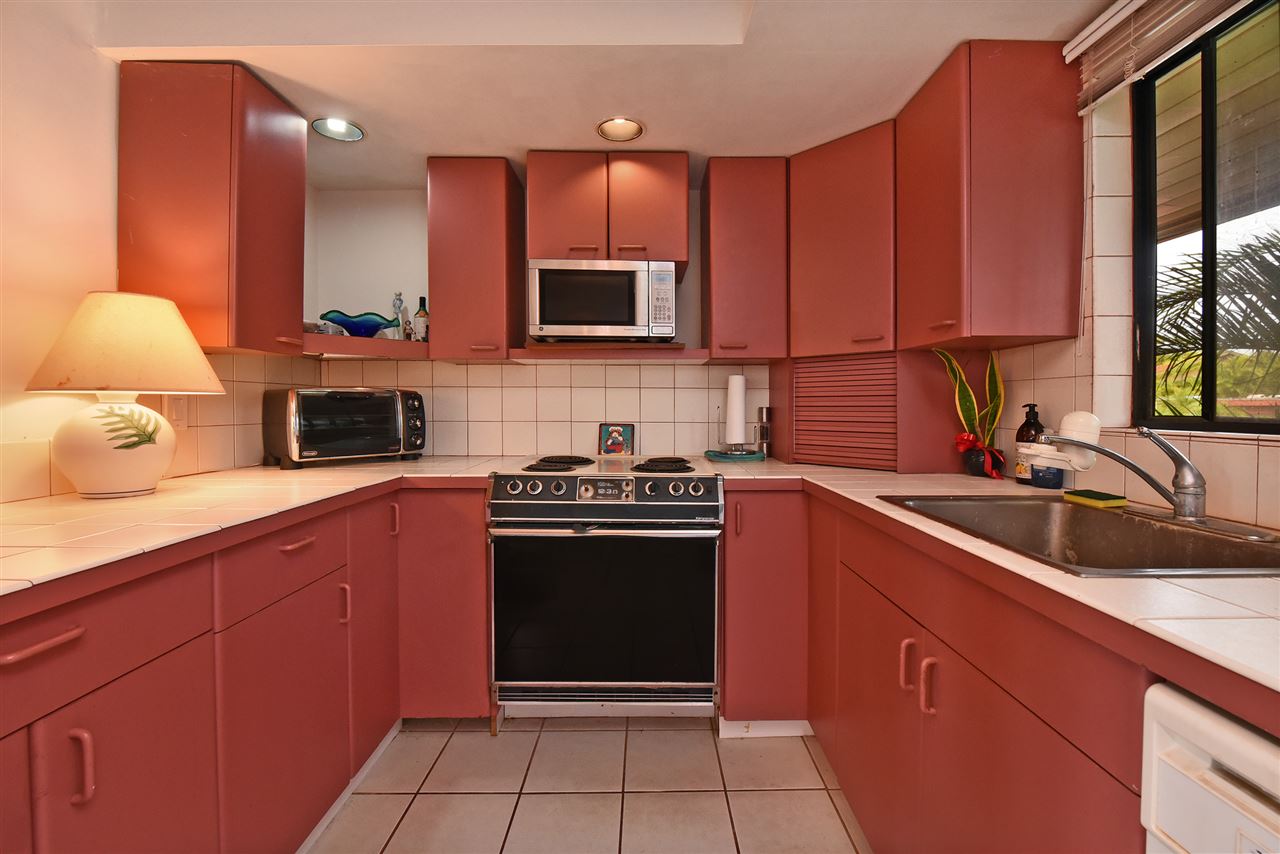 166 Halelo Street Lahaina, HI 96761 - Photo 20 of 27 a kitchen with stainless steel appliances granite countertop a stove a sink and a microwave