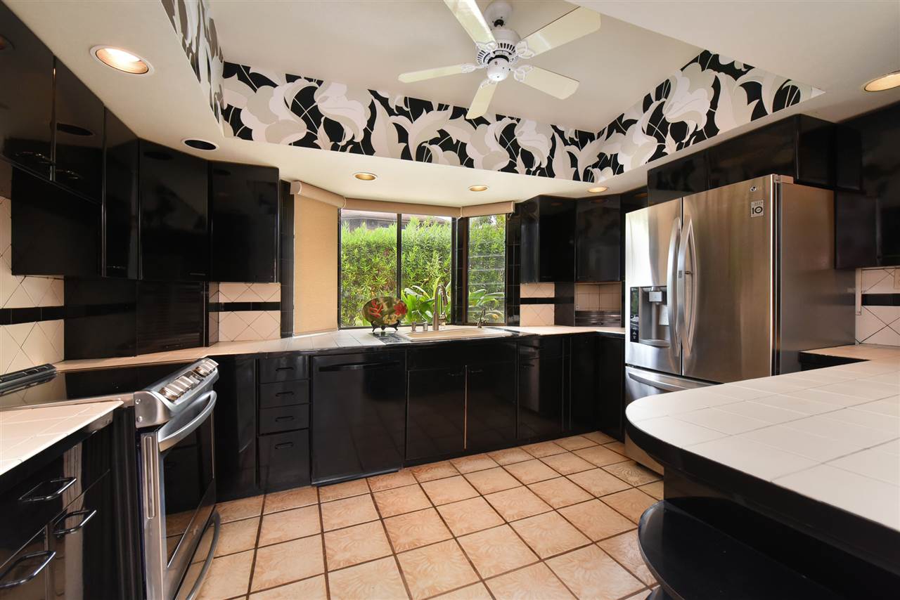 166 Halelo Street Lahaina, HI 96761 - Photo 4 of 27 a kitchen with a sink stainless steel appliances and cabinets