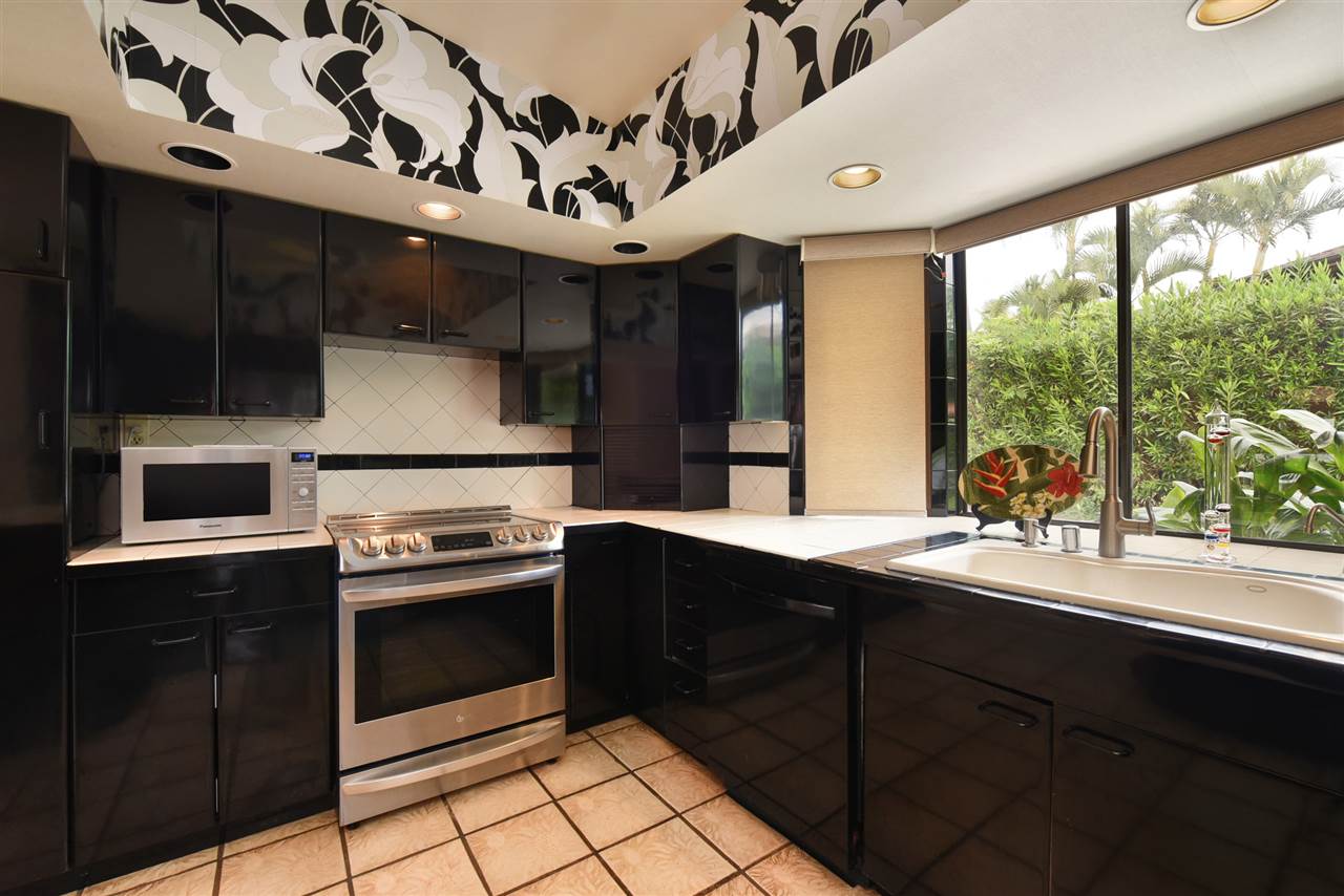 166 Halelo Street Lahaina, HI 96761 - Photo 7 of 27 a kitchen with stainless steel appliances granite countertop a sink and a stove