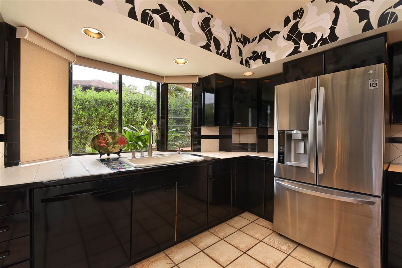 166 Halelo Street Lahaina, HI 96761 - Photo 9 of 27 a kitchen with stainless steel appliances granite countertop a refrigerator and a sink
