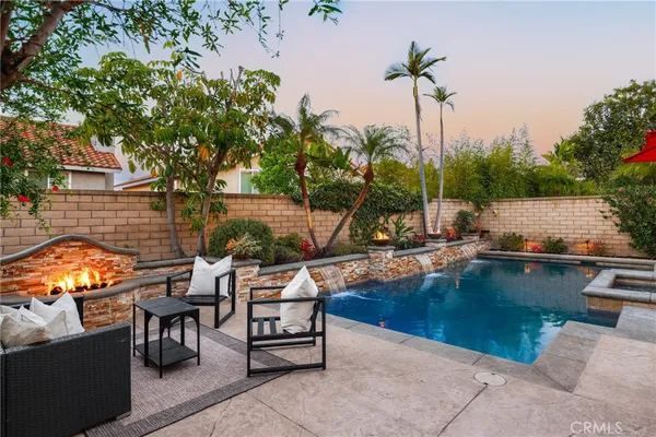 a view of swimming pool with outdoor seating and plants
