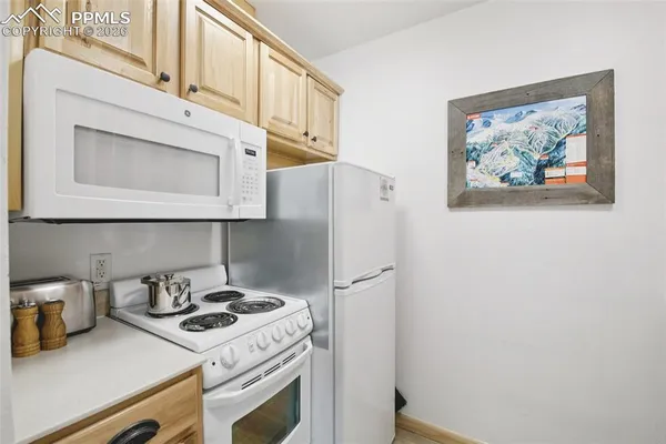 a kitchen with stainless steel appliances white cabinets and a stove top oven