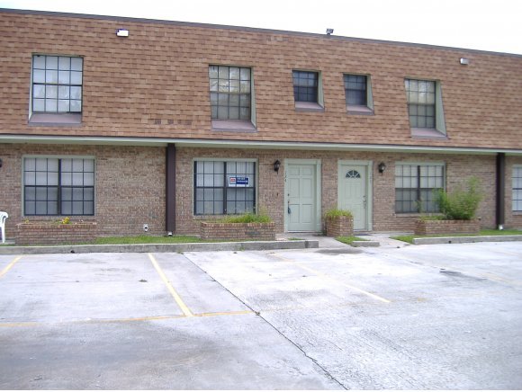 1300 Northeast Arlington, Unit 124 Palm Bay, FL 32905 - Photo 1 of 6 a brick house with a outdoor space