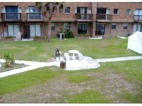 1300 Northeast Arlington, Unit 124 Palm Bay, FL 32905 - Photo 3 of 6 a front view of a house with a garden and plants