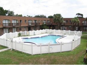 1300 Northeast Arlington, Unit 124 Palm Bay, FL 32905 - Photo 4 of 6 a view of a house with a yard and sitting area