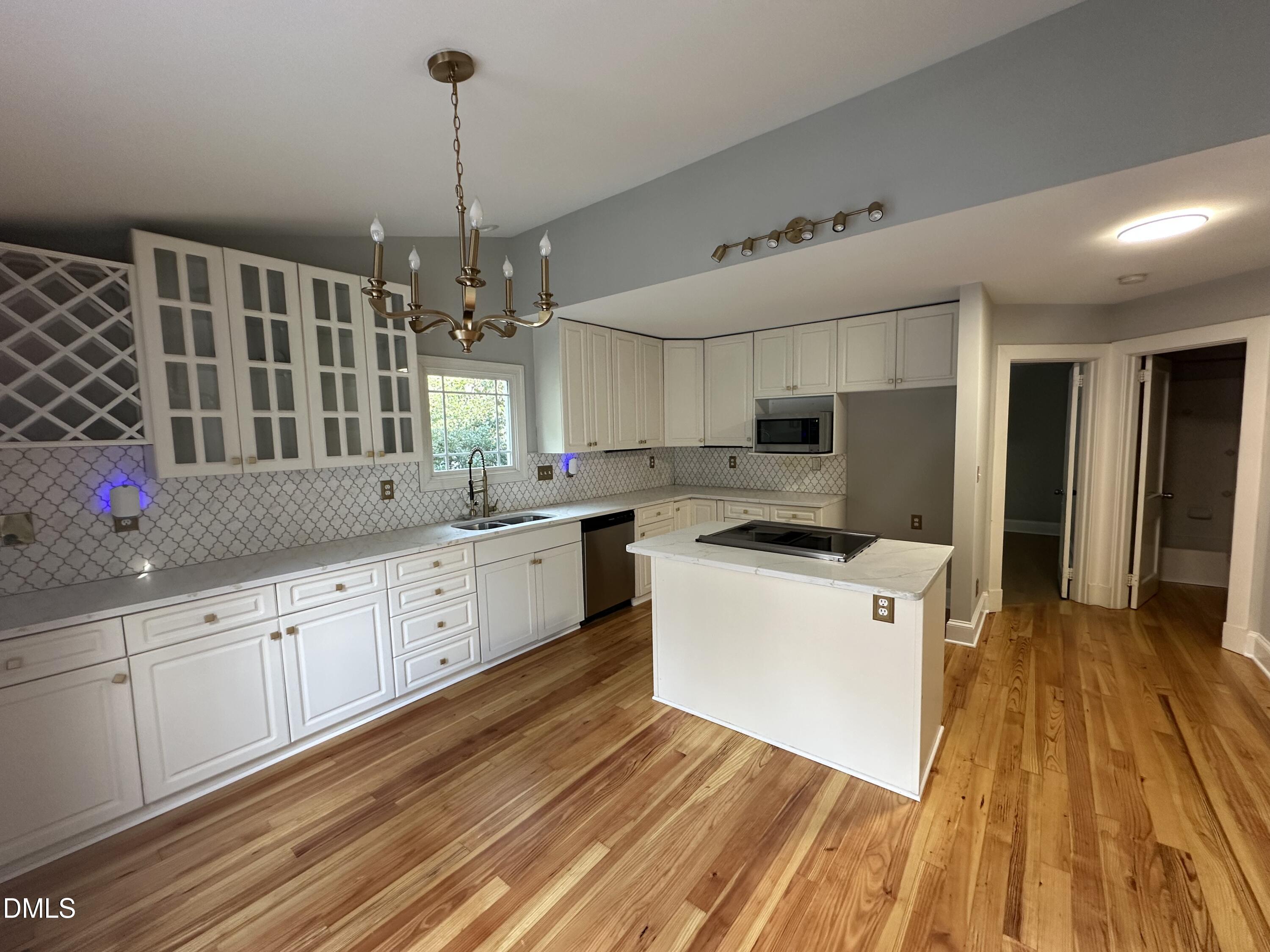 2610 Dover Road Raleigh, NC 27608 - Photo 16 of 53 a kitchen with granite countertop a sink cabinets and wooden floor