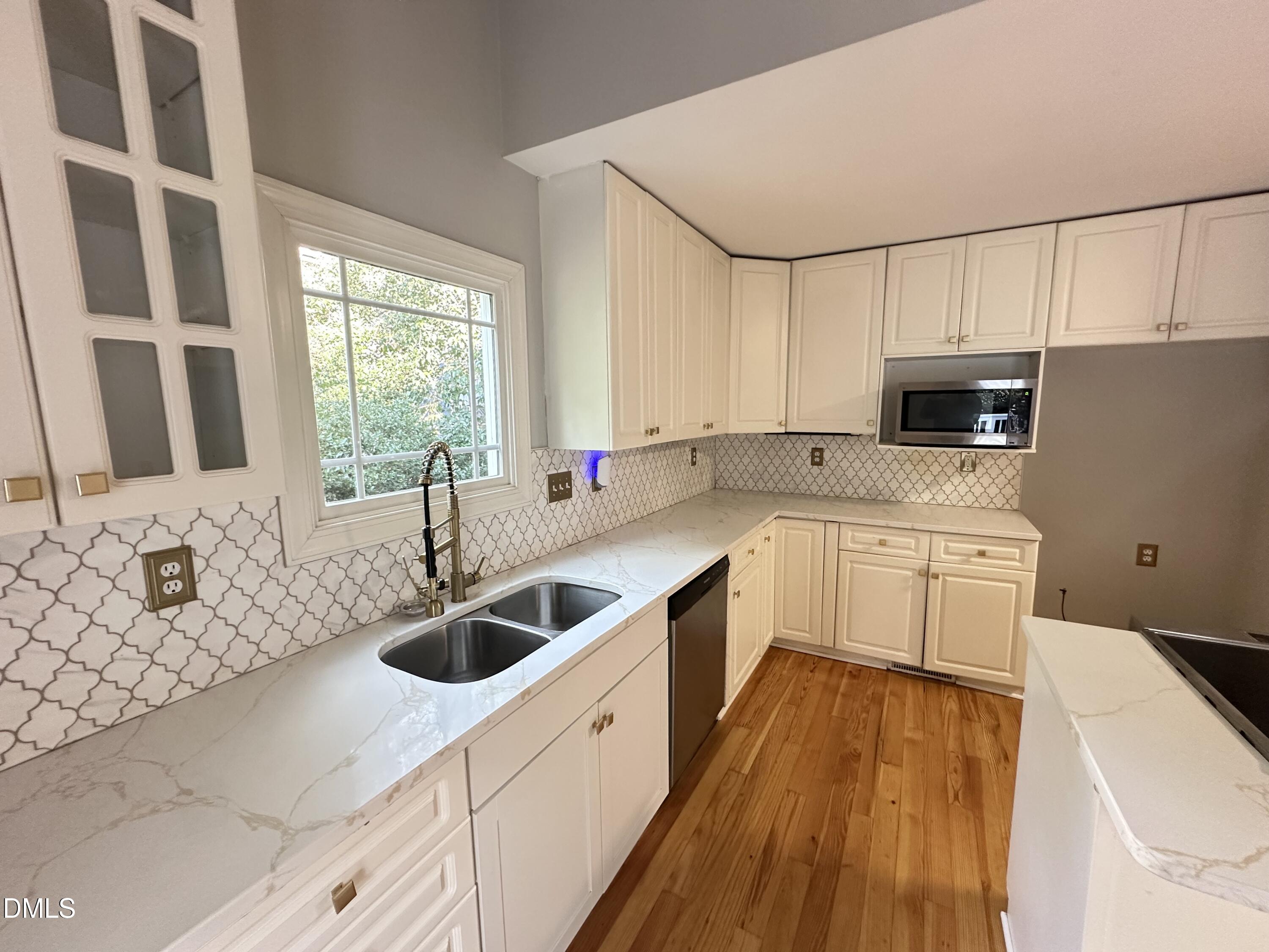 2610 Dover Road Raleigh, NC 27608 - Photo 17 of 53 a kitchen with granite countertop a sink a stove and cabinets