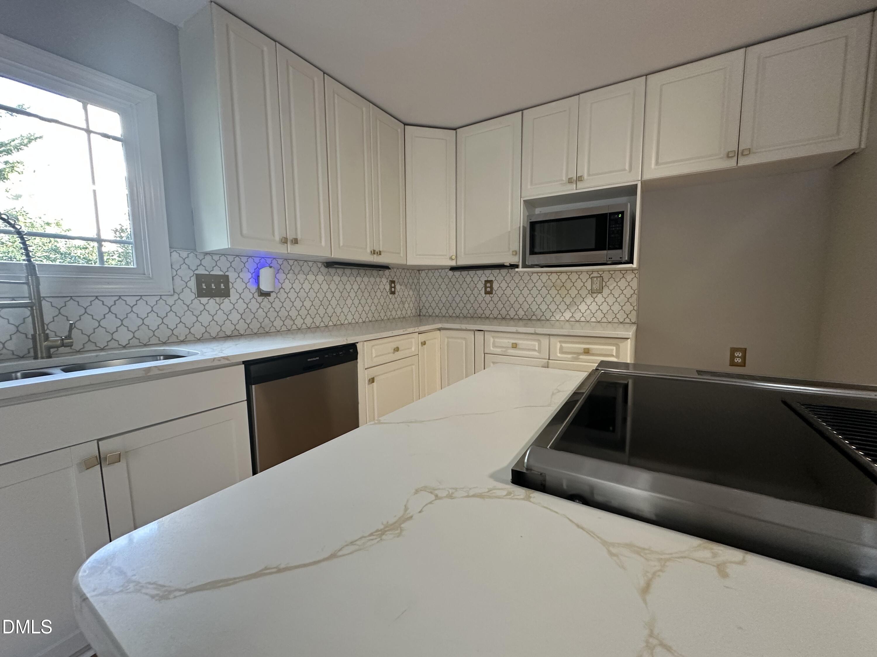 2610 Dover Road Raleigh, NC 27608 - Photo 18 of 53 a kitchen with granite countertop a sink a stove and cabinets