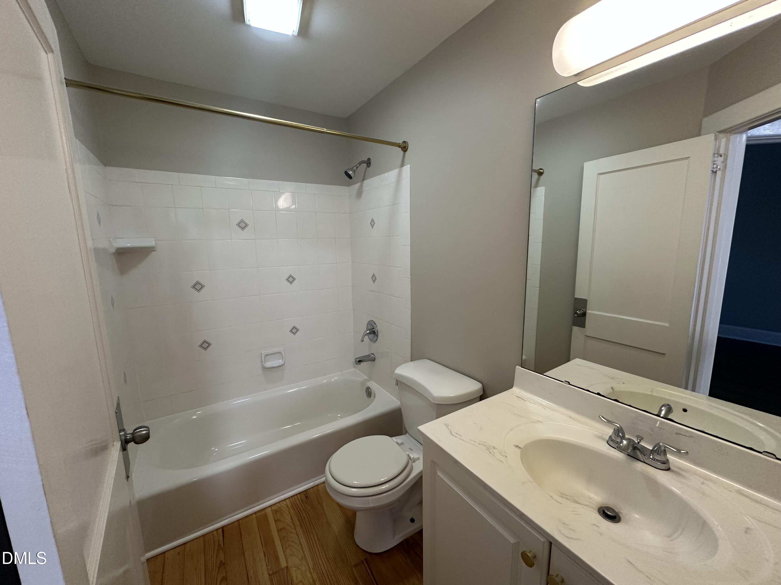 2610 Dover Road Raleigh, NC 27608 - Photo 19 of 53 a bathroom with a sink a toilet and shower