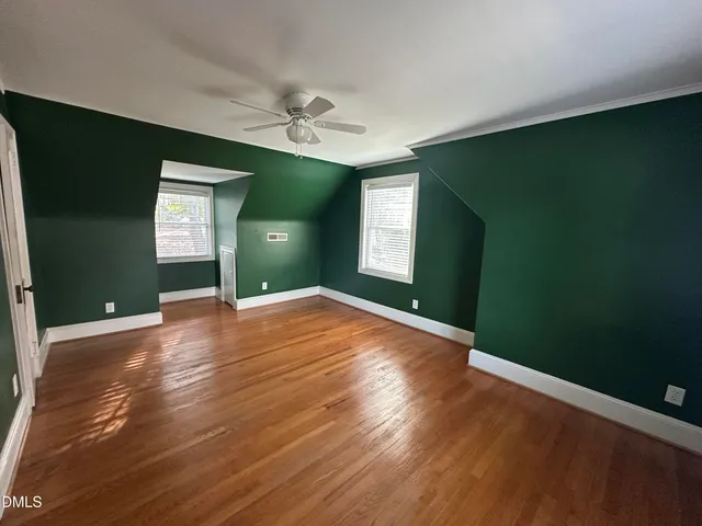 an empty room with closet and wooden floor