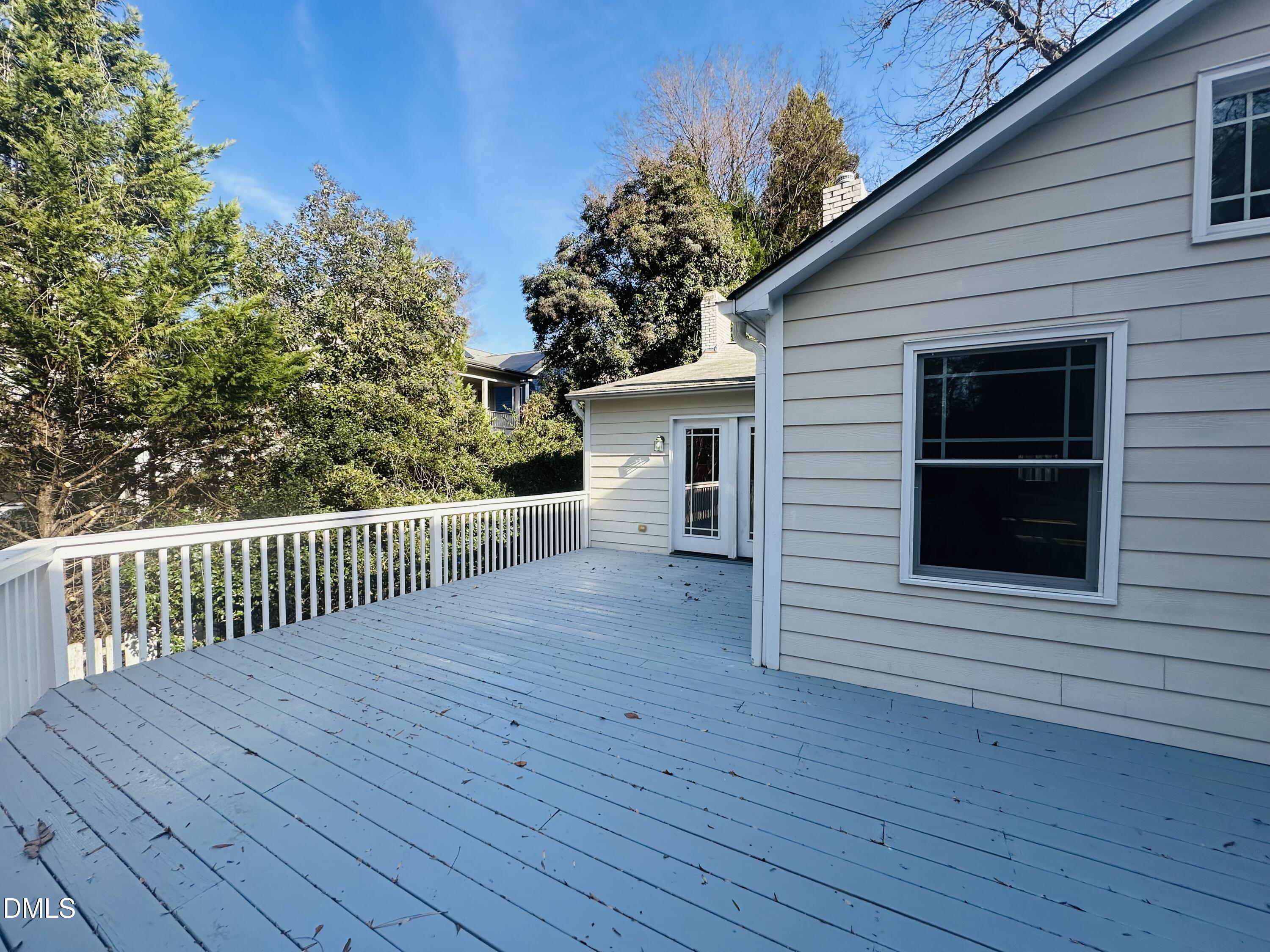 2610 Dover Road Raleigh, NC 27608 - Photo 45 of 53 a view of a porch with wooden floor and fence