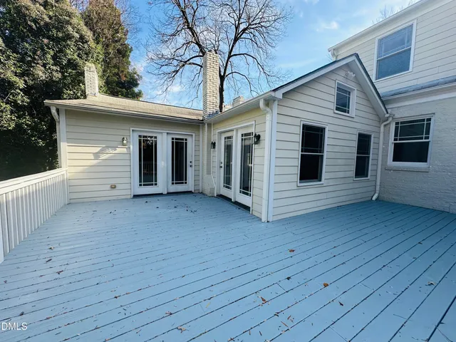 a view of a house with wooden deck